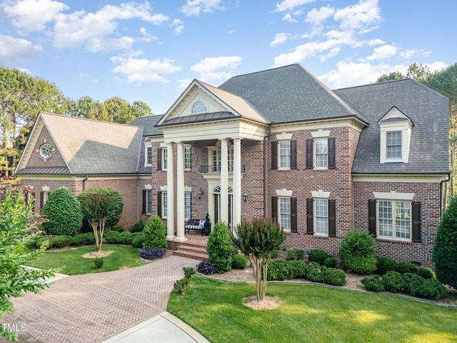 5768 Cavanaugh Dr, Raleigh, NC 27614 - greek revival inspired property featuring brick siding, a front lawn, and a shingled roof