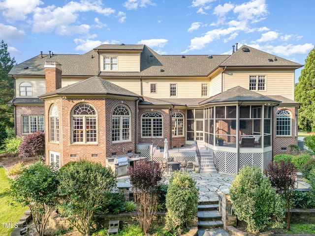 5768 Cavanaugh Dr, Raleigh, NC 27614 - back of house with a sunroom, brick siding, and a patio area