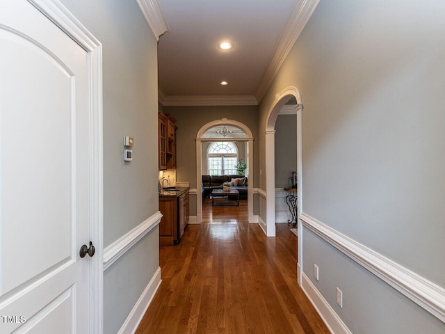 5768 Cavanaugh Dr, Raleigh, NC 27614 - corridor featuring crown molding, dark wood-type flooring, arched walkways, and recessed lighting