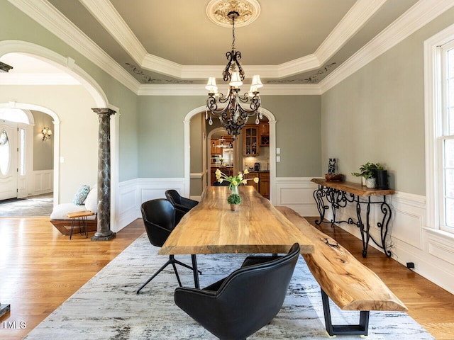 5768 Cavanaugh Dr, Raleigh, NC 27614 - dining area featuring arched walkways, a chandelier, plenty of natural light, a wainscoted wall, and crown molding