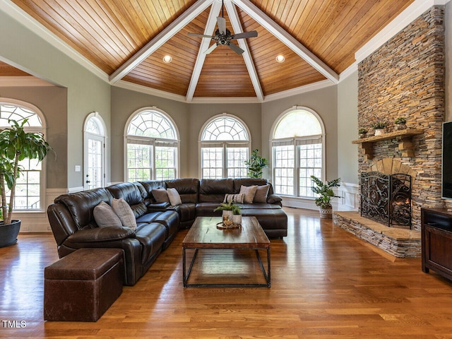 5768 Cavanaugh Dr, Raleigh, NC 27614 - living room with a towering ceiling, a fireplace, a wood ceiling with exposed beams, plenty of natural light, and wood finished floors