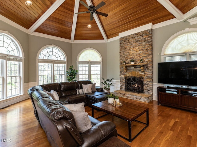 5768 Cavanaugh Dr, Raleigh, NC 27614 - living area featuring a wood ceiling with exposed beams, a ceiling fan, a fireplace, wood finished floors, and high vaulted ceiling