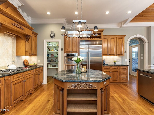 5768 Cavanaugh Dr, Raleigh, NC 27614 - kitchen with open shelves, appliances with stainless steel finishes, brown cabinetry, light wood-style flooring, and crown molding