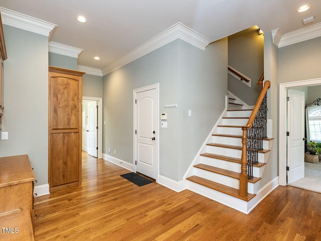 5768 Cavanaugh Dr, Raleigh, NC 27614 - entrance foyer with light wood-style floors, recessed lighting, stairs, and ornamental molding