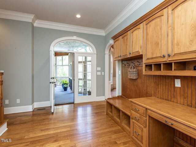 5768 Cavanaugh Dr, Raleigh, NC 27614 - mudroom with light wood finished floors, crown molding, arched walkways, and recessed lighting