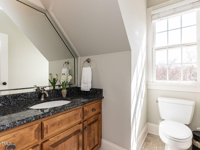 5768 Cavanaugh Dr, Raleigh, NC 27614 - half bathroom featuring vanity, healthy amount of natural light, vaulted ceiling, and tile patterned flooring