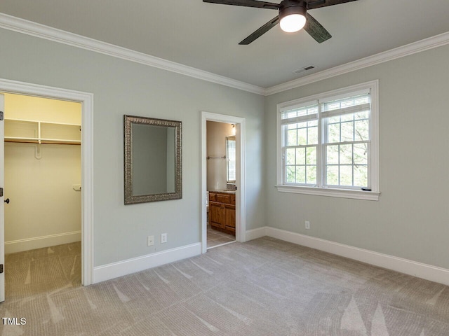 5768 Cavanaugh Dr, Raleigh, NC 27614 - unfurnished bedroom with crown molding, carpet floors, a spacious closet, connected bathroom, and a closet