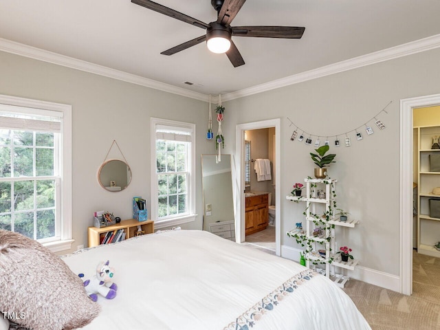 5768 Cavanaugh Dr, Raleigh, NC 27614 - bedroom with crown molding, light carpet, a spacious closet, connected bathroom, and a ceiling fan