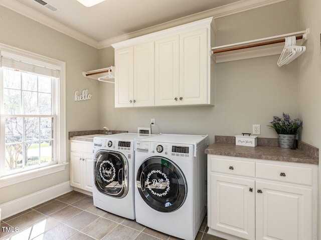 5768 Cavanaugh Dr, Raleigh, NC 27614 - laundry room with cabinet space, independent washer and dryer, plenty of natural light, crown molding, and light tile patterned floors