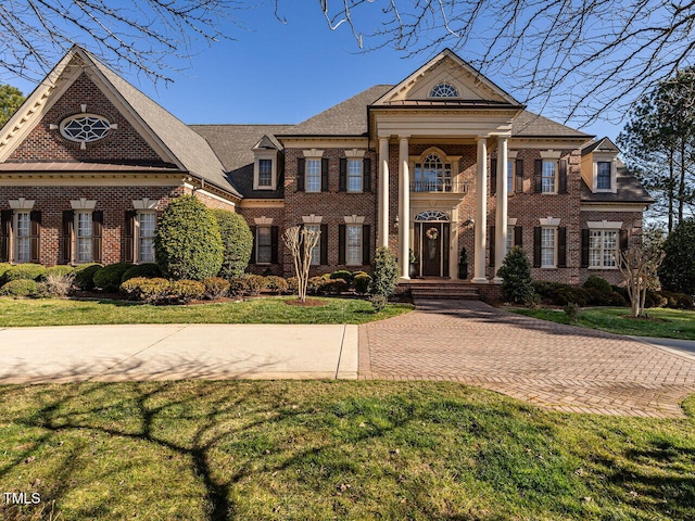 5768 Cavanaugh Dr, Raleigh, NC 27614 - greek revival house with brick siding and a front lawn