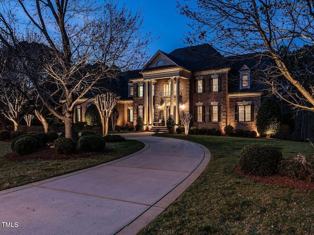 5768 Cavanaugh Dr, Raleigh, NC 27614 - view of front of home featuring brick siding, curved driveway, and a front lawn