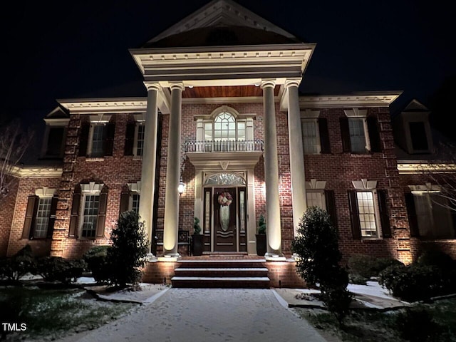 5768 Cavanaugh Dr, Raleigh, NC 27614 - exterior entry at night featuring brick siding and a balcony