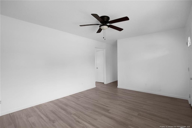 4709 Alamance Rd, Fayetteville, NC 28304 - spare room with wood finished floors, a ceiling fan, and baseboards