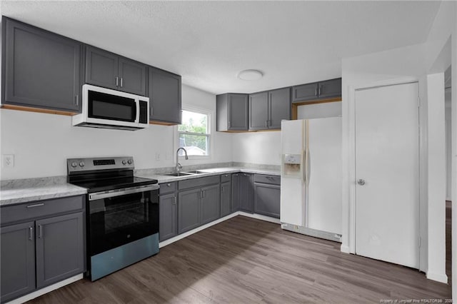 4709 Alamance Rd, Fayetteville, NC 28304 - kitchen with white appliances, a sink, gray cabinets, light countertops, and a textured ceiling