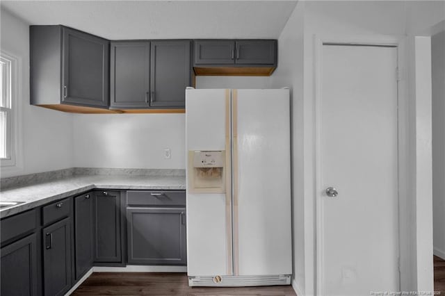 4709 Alamance Rd, Fayetteville, NC 28304 - kitchen with white refrigerator with ice dispenser, gray cabinets, dark wood-type flooring, and light countertops