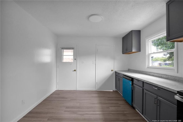 4709 Alamance Rd, Fayetteville, NC 28304 - kitchen with dishwasher, plenty of natural light, light countertops, wood finished floors, and a textured ceiling