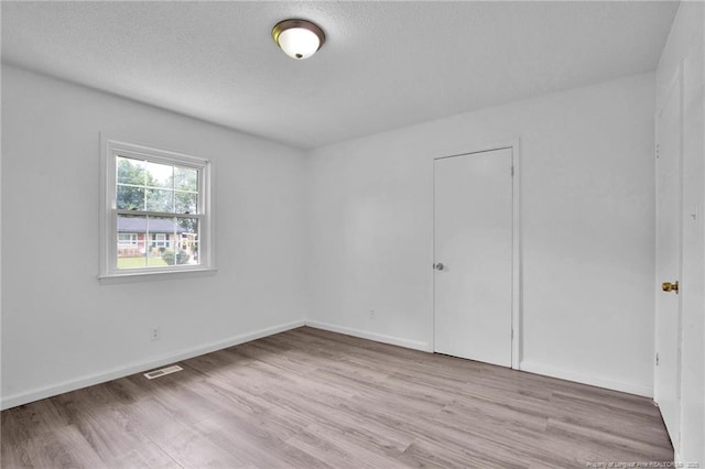 4709 Alamance Rd, Fayetteville, NC 28304 - unfurnished bedroom featuring wood finished floors, baseboards, and a textured ceiling