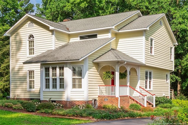 1718 Carthage St, Sanford, NC 27330 - view of front of home featuring a shingled roof, covered porch, and a chimney