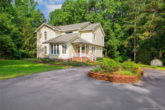 1718 Carthage St, Sanford, NC 27330 - view of front of home with driveway, a front lawn, and a chimney