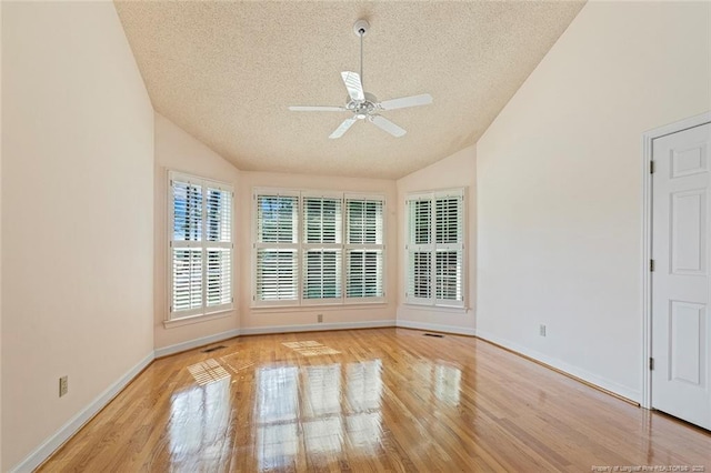 1718 Carthage St, Sanford, NC 27330 - unfurnished room featuring a textured ceiling, vaulted ceiling, ceiling fan, wood finished floors, and baseboards