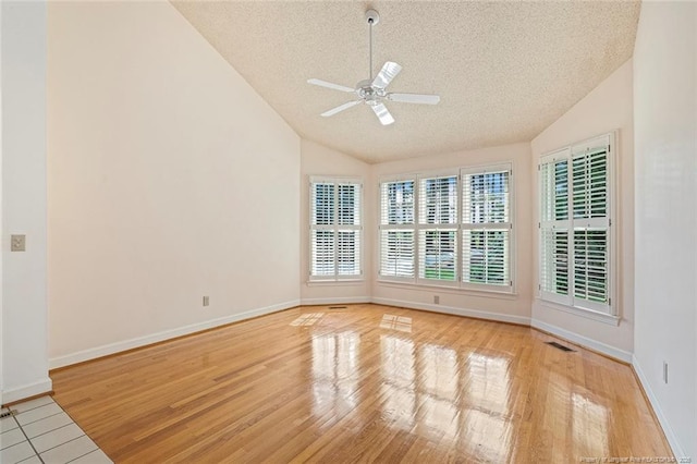 1718 Carthage St, Sanford, NC 27330 - unfurnished room with lofted ceiling, a textured ceiling, ceiling fan, wood finished floors, and baseboards