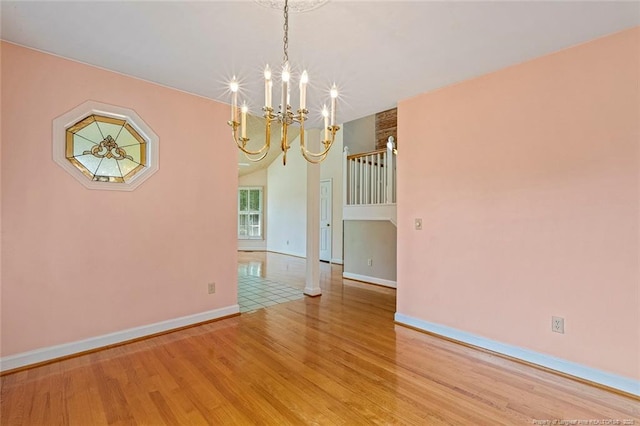 1718 Carthage St, Sanford, NC 27330 - empty room with a chandelier, light wood-type flooring, and baseboards