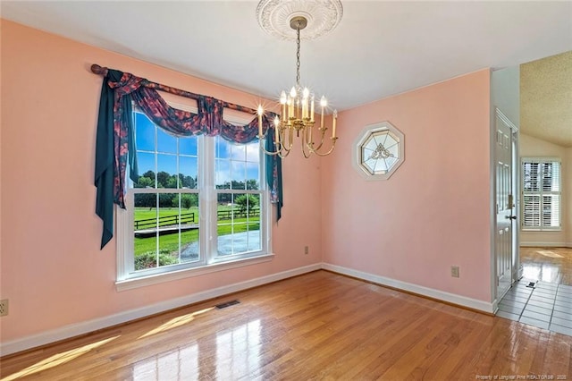 1718 Carthage St, Sanford, NC 27330 - empty room with a chandelier, baseboards, and wood finished floors