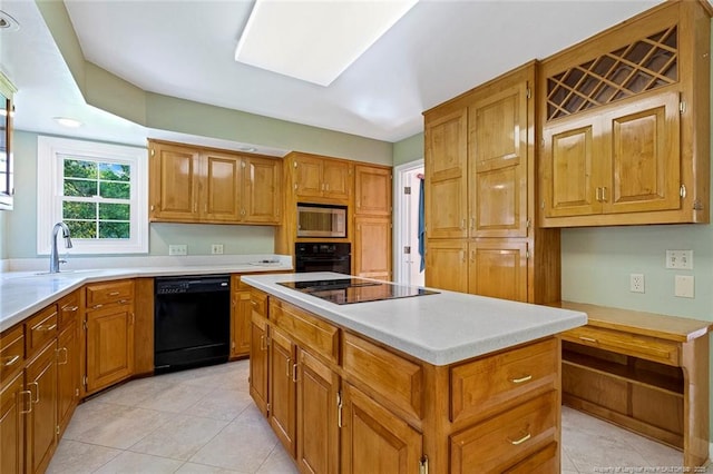 1718 Carthage St, Sanford, NC 27330 - kitchen with black appliances, a kitchen island, and brown cabinetry