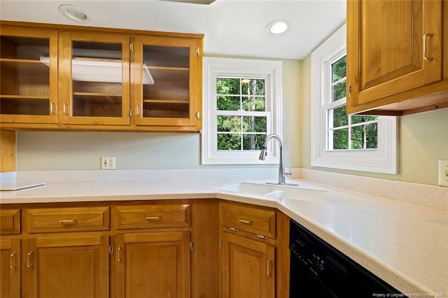 1718 Carthage St, Sanford, NC 27330 - kitchen featuring a sink, black dishwasher, light countertops, brown cabinetry, and recessed lighting