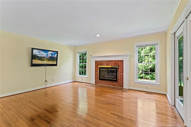 1718 Carthage St, Sanford, NC 27330 - unfurnished living room featuring crown molding, plenty of natural light, light wood-type flooring, and baseboards
