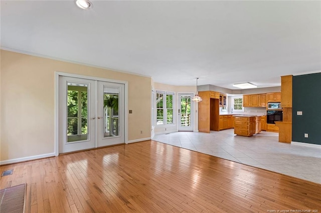 1718 Carthage St, Sanford, NC 27330 - unfurnished living room featuring baseboards and light wood finished floors