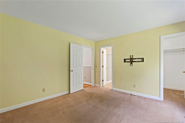 1718 Carthage St, Sanford, NC 27330 - unfurnished bedroom featuring carpet floors, a spacious closet, baseboards, and a closet