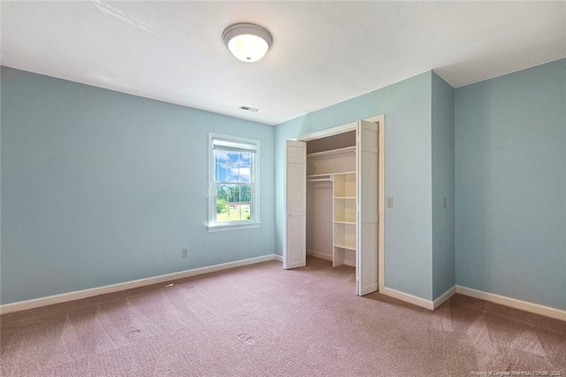 1718 Carthage St, Sanford, NC 27330 - unfurnished bedroom featuring carpet flooring, a closet, and baseboards