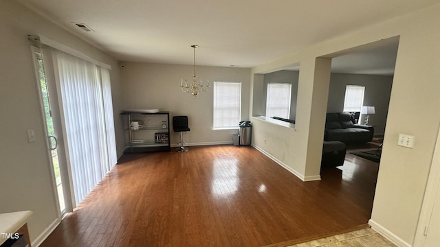 6005 Namozine Ct, Raleigh, NC 27610 - living room featuring wood finished floors, a chandelier, and baseboards