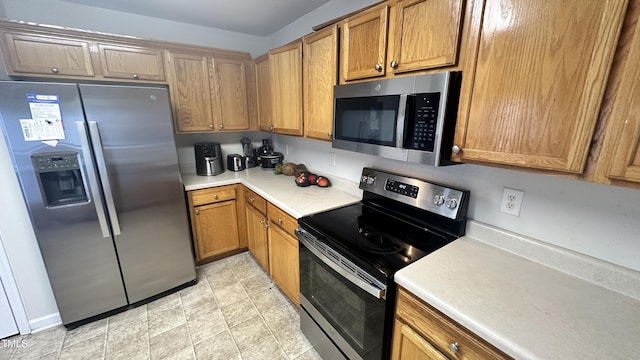 6005 Namozine Ct, Raleigh, NC 27610 - kitchen with appliances with stainless steel finishes, light countertops, and brown cabinetry