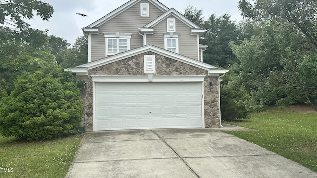 6005 Namozine Ct, Raleigh, NC 27610 - view of front of home with stone siding, driveway, an attached garage, and a front yard