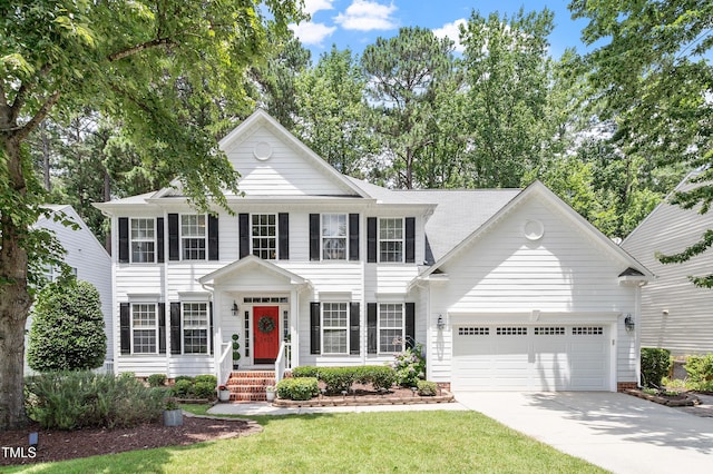 2422 Castleburg Dr, Apex, NC 27523 - colonial inspired home with concrete driveway, an attached garage, and a front yard