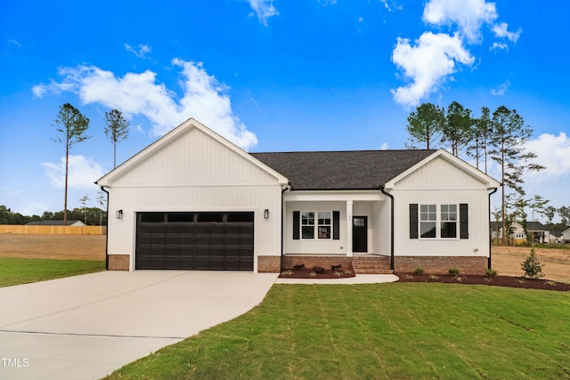 162 Gumtop Dr, Zebulon, NC 27597 - modern inspired farmhouse featuring a garage, concrete driveway, a front yard, and a shingled roof