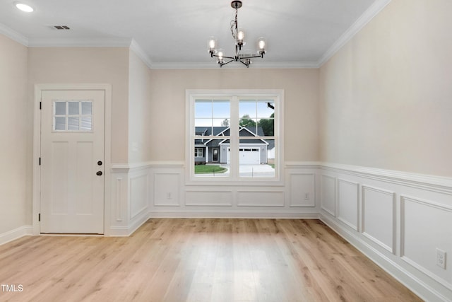 162 Gumtop Dr, Zebulon, NC 27597 - unfurnished dining area with a chandelier, light wood-type flooring, a wainscoted wall, and ornamental molding