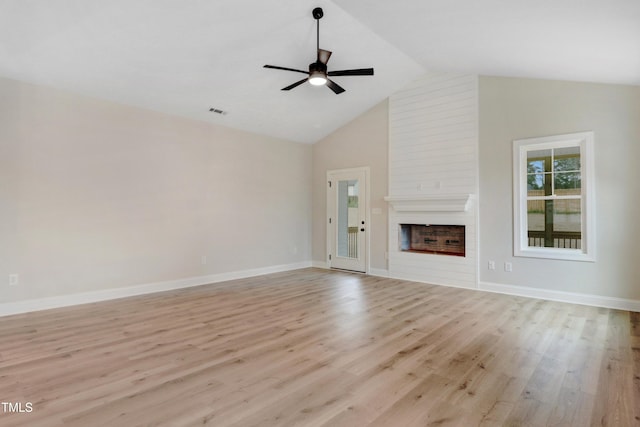 162 Gumtop Dr, Zebulon, NC 27597 - unfurnished living room with high vaulted ceiling, a fireplace, a ceiling fan, light wood-style flooring, and baseboards