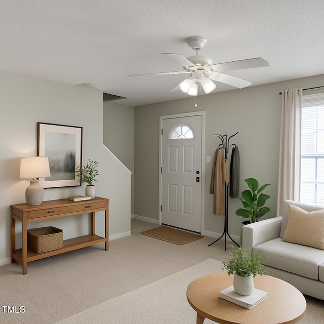 5100 Mass Rock Dr, Raleigh, NC 27610 - entrance foyer with light carpet, a ceiling fan, and a textured ceiling