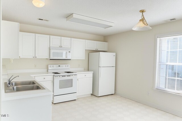 5100 Mass Rock Dr, Raleigh, NC 27610 - kitchen with white appliances, light floors, white cabinets, and light countertops