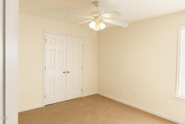 5100 Mass Rock Dr, Raleigh, NC 27610 - unfurnished bedroom with light carpet, a closet, and a ceiling fan