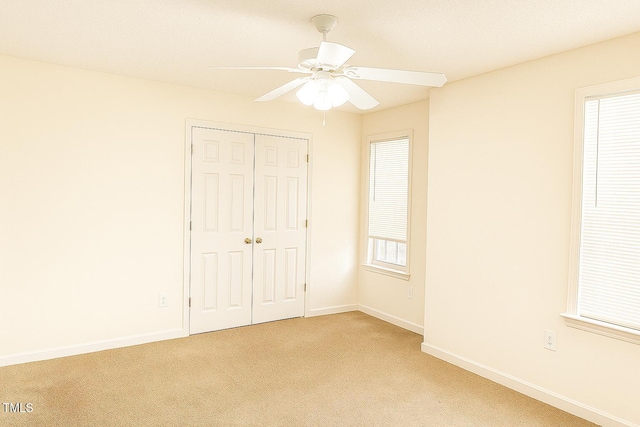 5100 Mass Rock Dr, Raleigh, NC 27610 - unfurnished bedroom with light colored carpet, a closet, and ceiling fan
