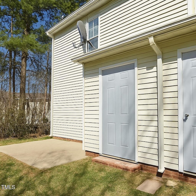 5100 Mass Rock Dr, Raleigh, NC 27610 - property entrance featuring a patio area and a lawn