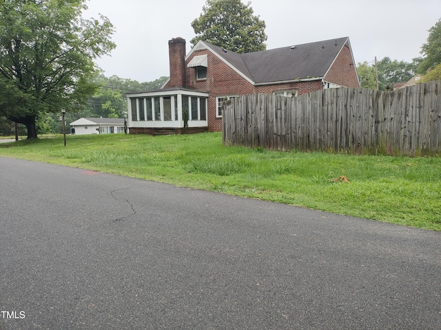 339 E Meadow Rd, Eden, NC 27288 - view of front of property with a chimney, a sunroom, and brick siding