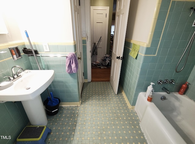 339 E Meadow Rd, Eden, NC 27288 - full bathroom featuring tile walls, a wainscoted wall, tub / shower combination, and a sink