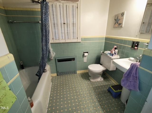 339 E Meadow Rd, Eden, NC 27288 - bathroom featuring toilet, a wainscoted wall, a sink, shower / bath combo, and tile walls