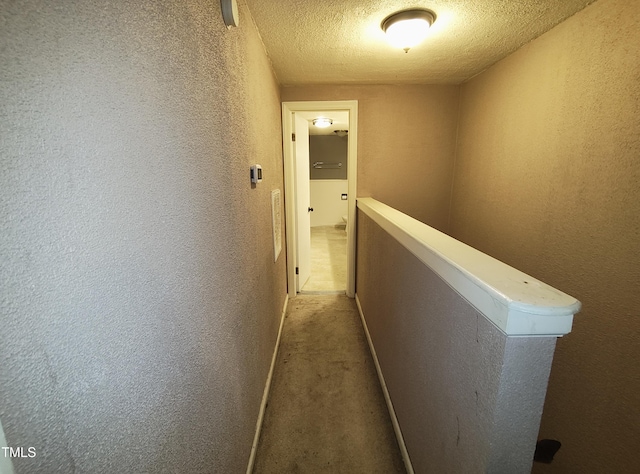 339 E Meadow Rd, Eden, NC 27288 - hallway featuring a textured wall, a textured ceiling, an upstairs landing, and carpet floors
