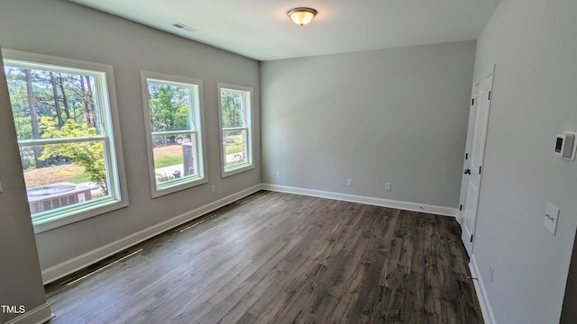 691 Bandon Aly, Cary, NC 27513 - empty room with healthy amount of natural light, dark wood finished floors, and baseboards